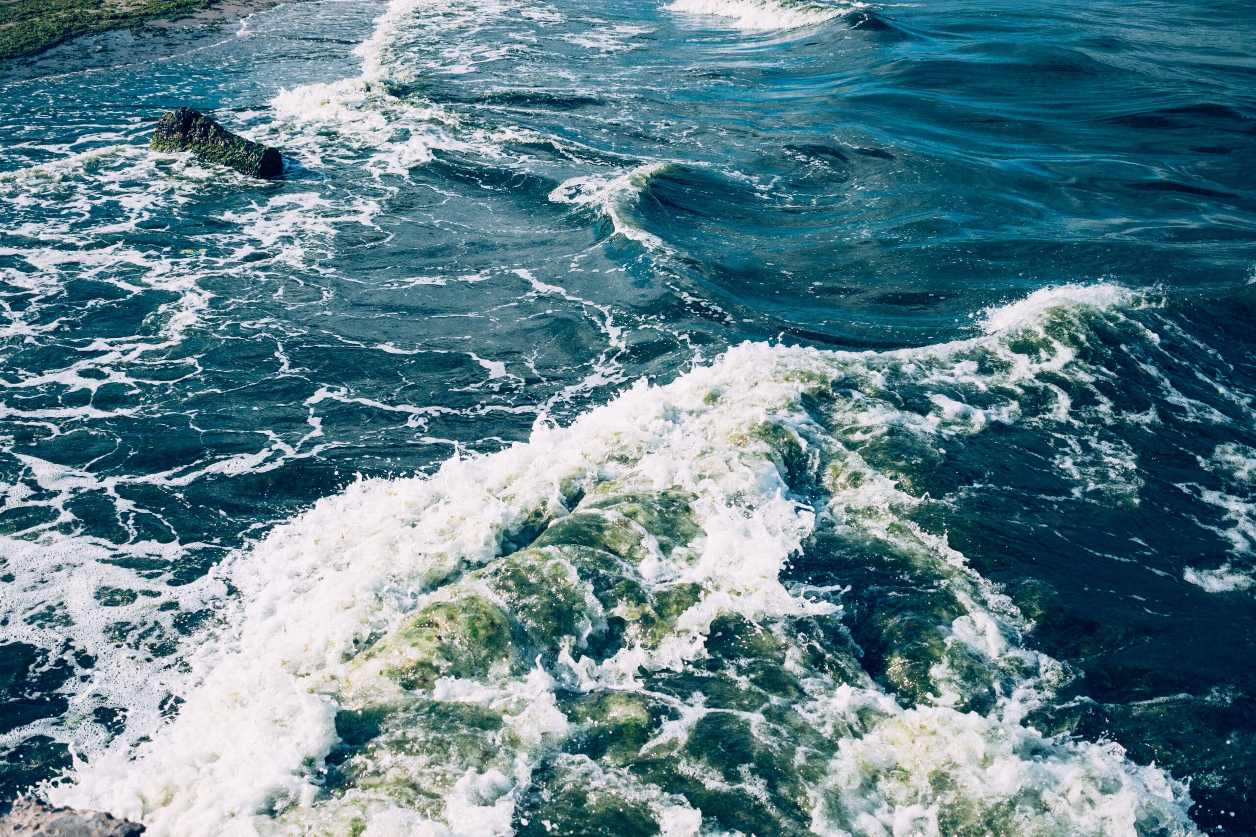 Blue sea with foam from the waves