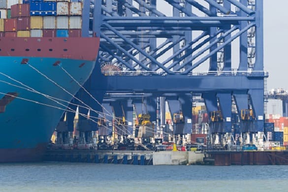 Container ship docked unloading large containers in port Liverpool working on net-zero maritime project